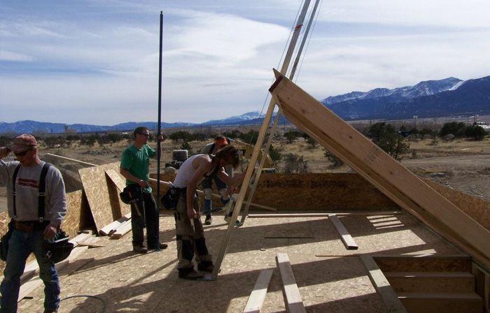 Group of construction workers working on an unfinished house