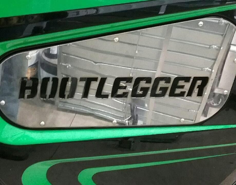 Chrome panel on green surface with bold black “BOOTLEGGER” lettering