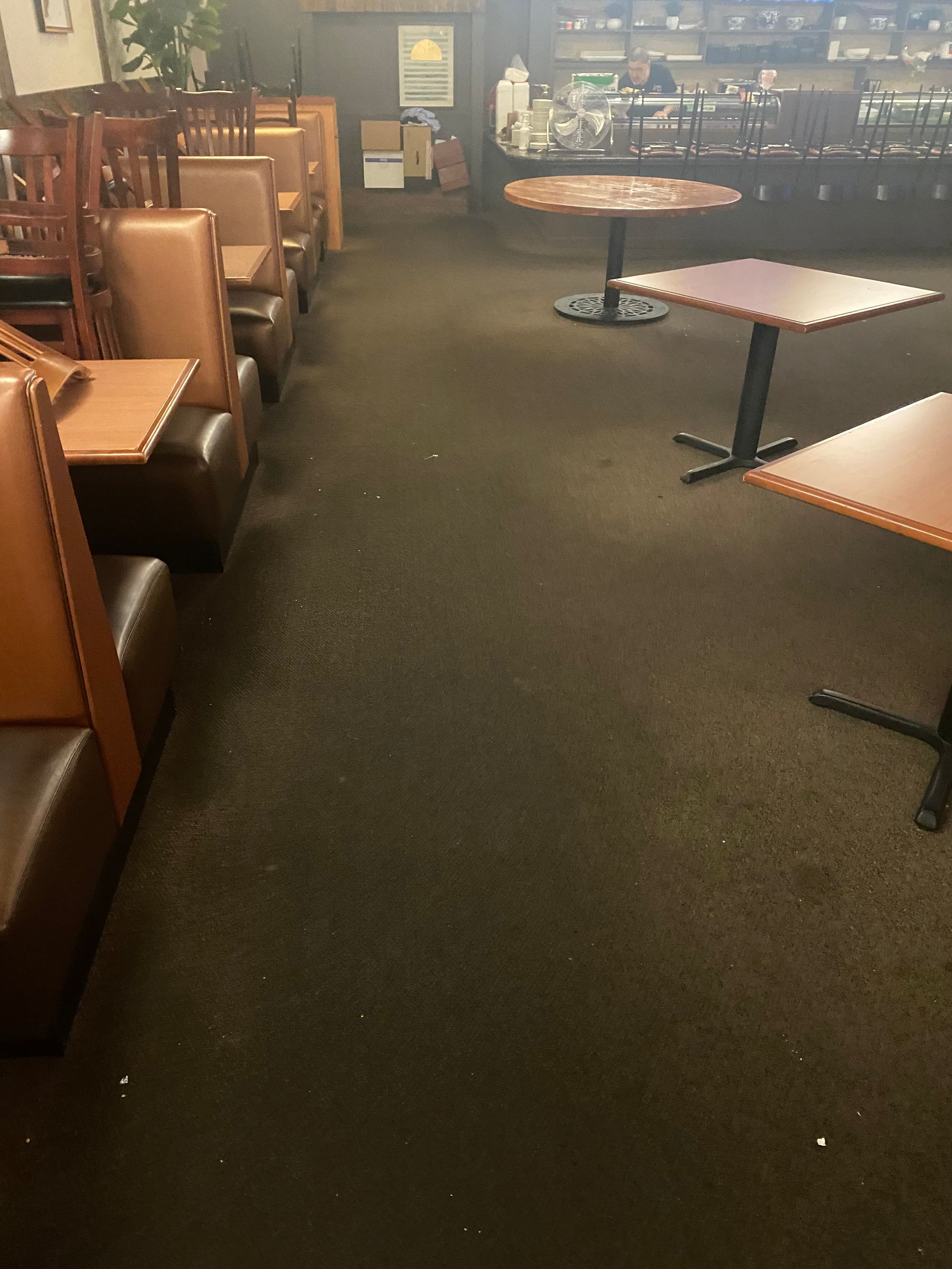 A restaurant with tables and booths in it
