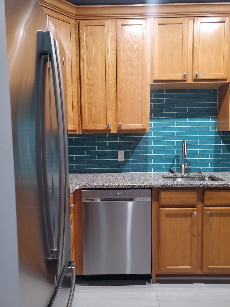 A kitchen with stainless steel appliances and wooden cabinets