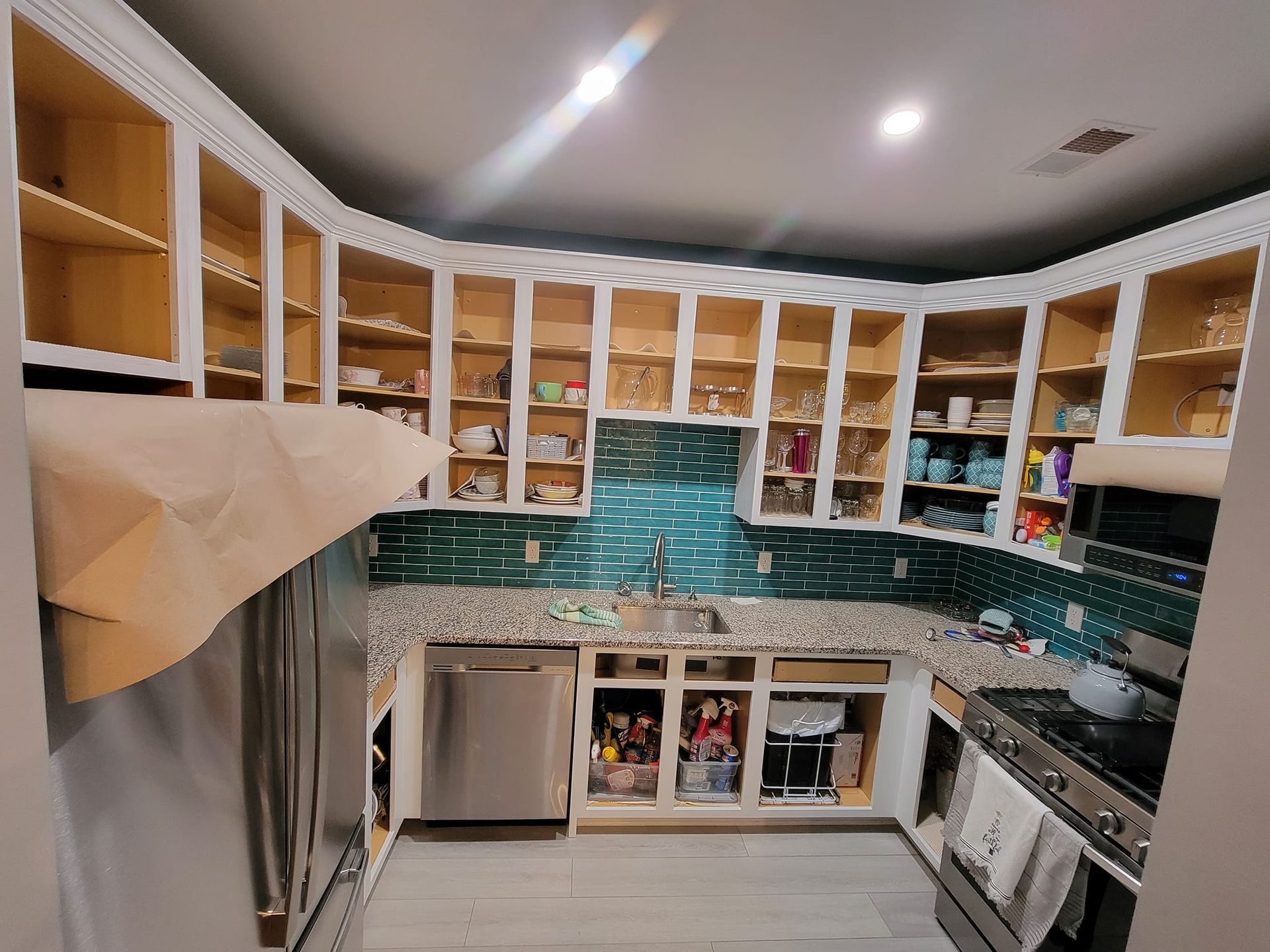 A kitchen with stainless steel appliances and wooden cabinets
