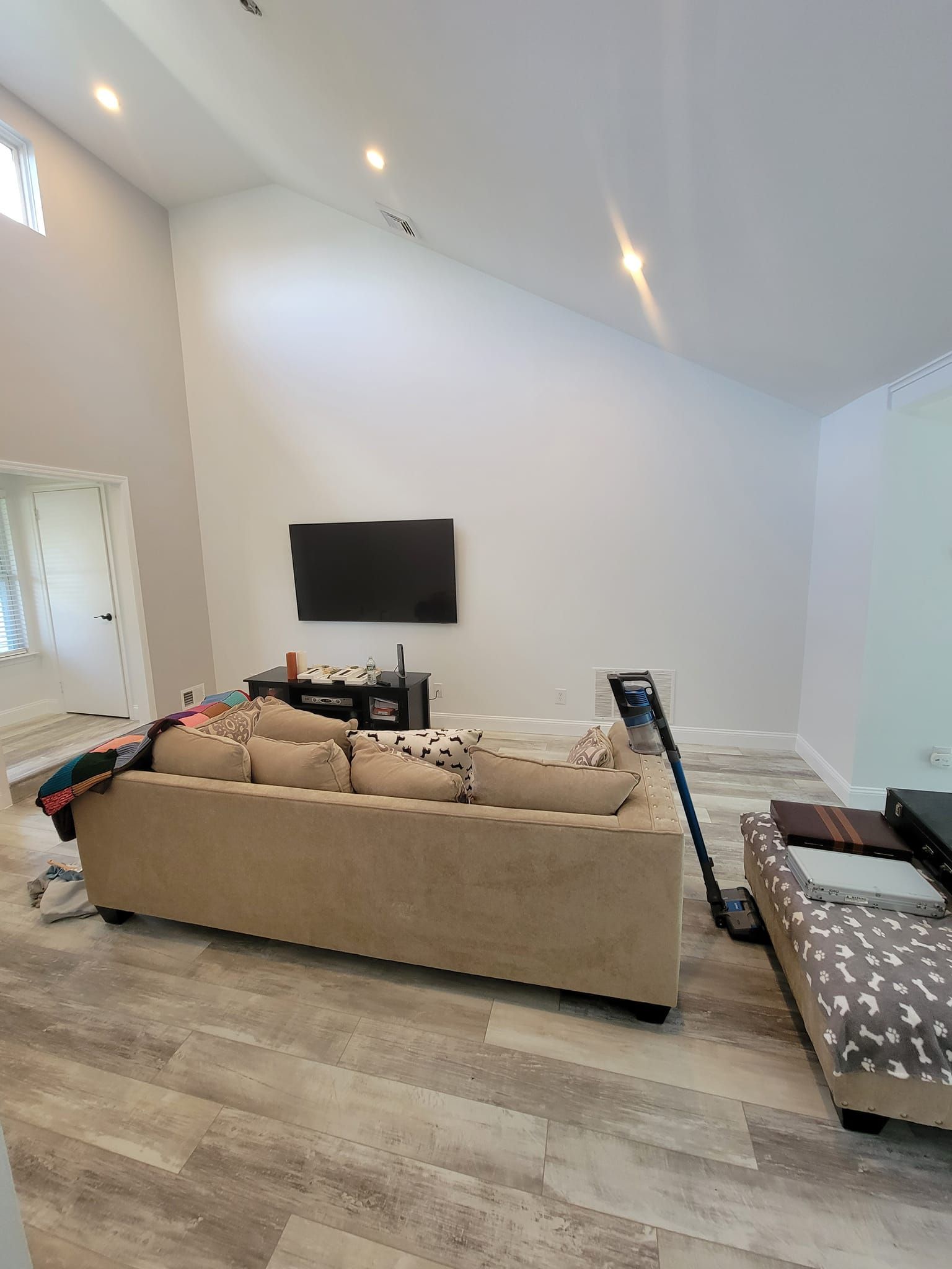 A living room with a couch and a flat screen tv