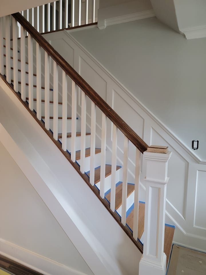 A staircase with a white railing and wooden steps
