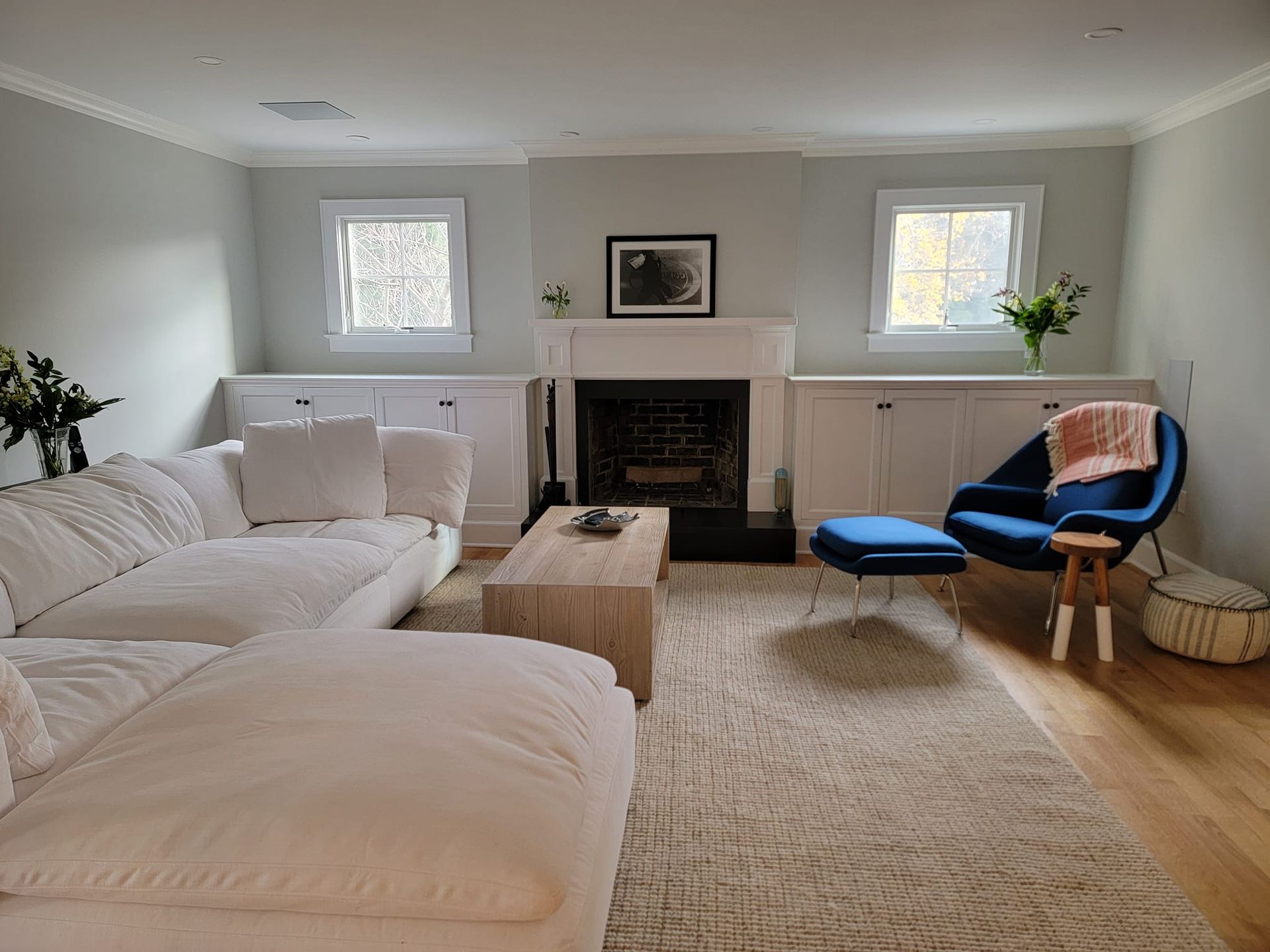 A living room with a couch , chair , coffee table and fireplace.