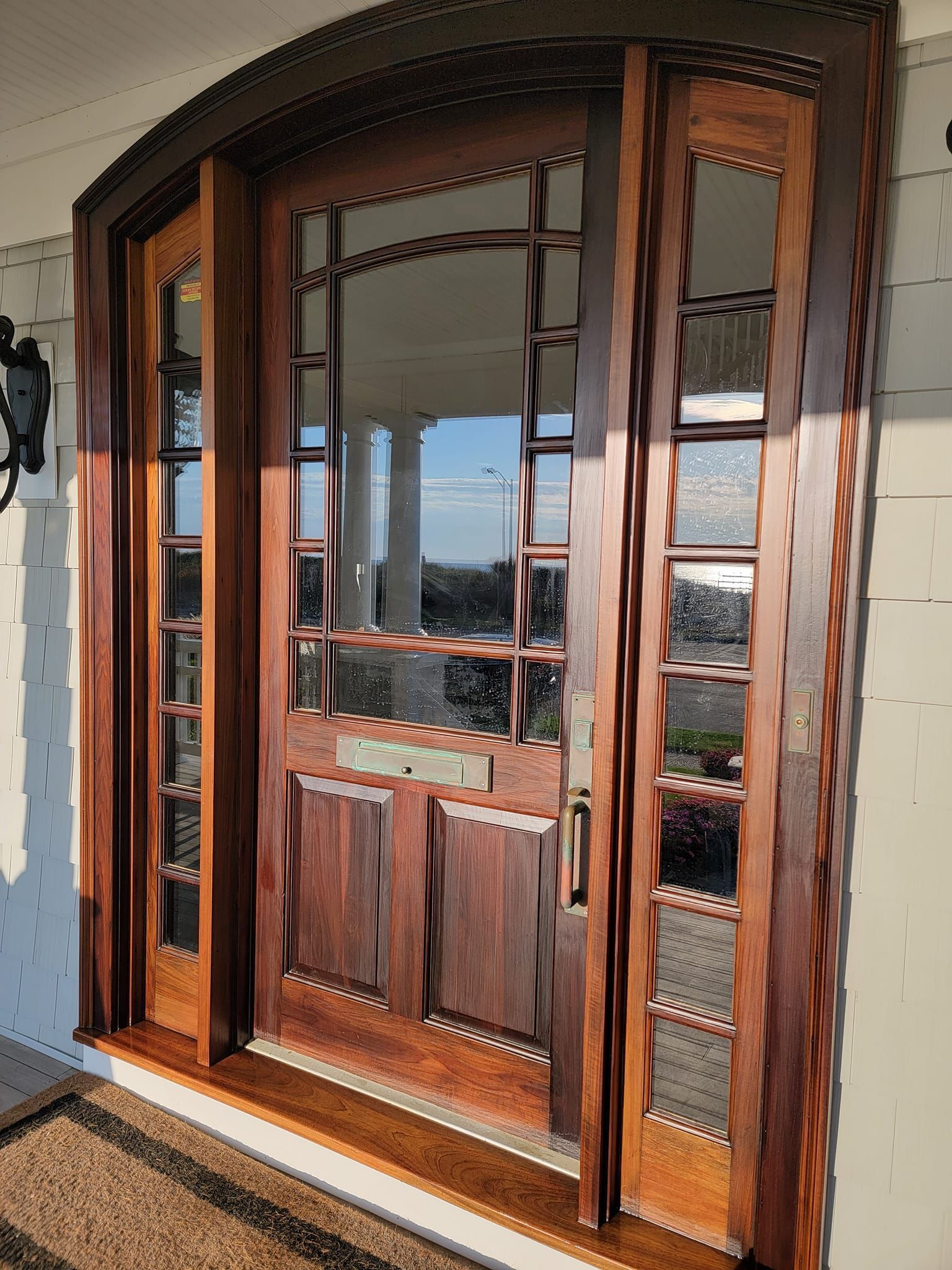A large wooden door with sliding glass doors