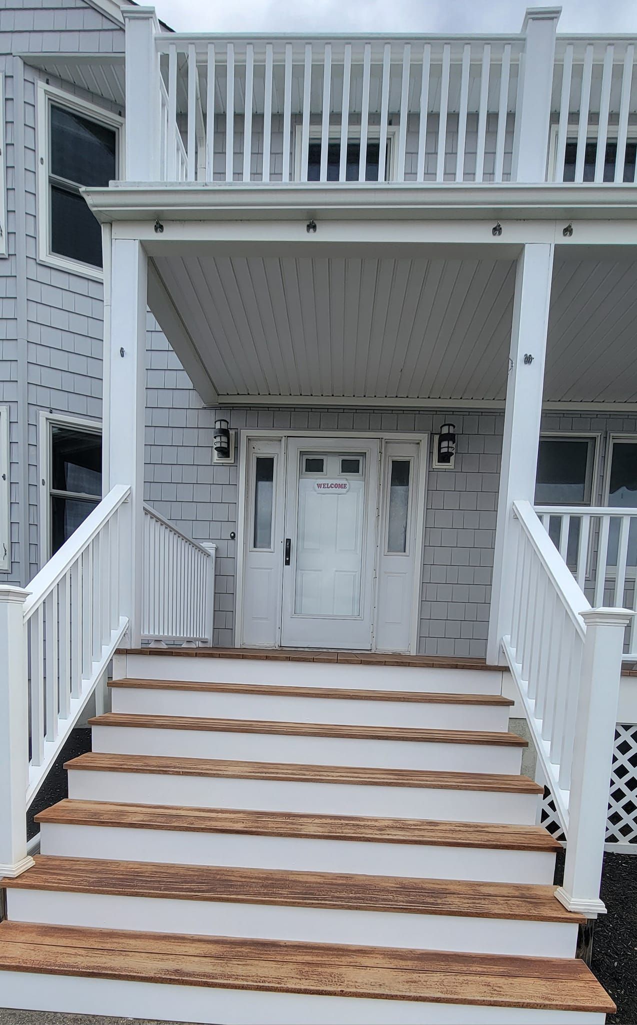 A white house with stairs leading up to the front door