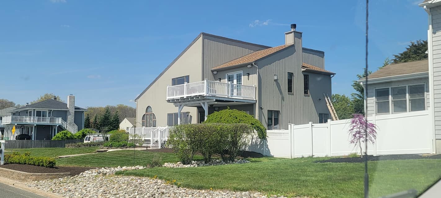 A large house with a white fence in front of it