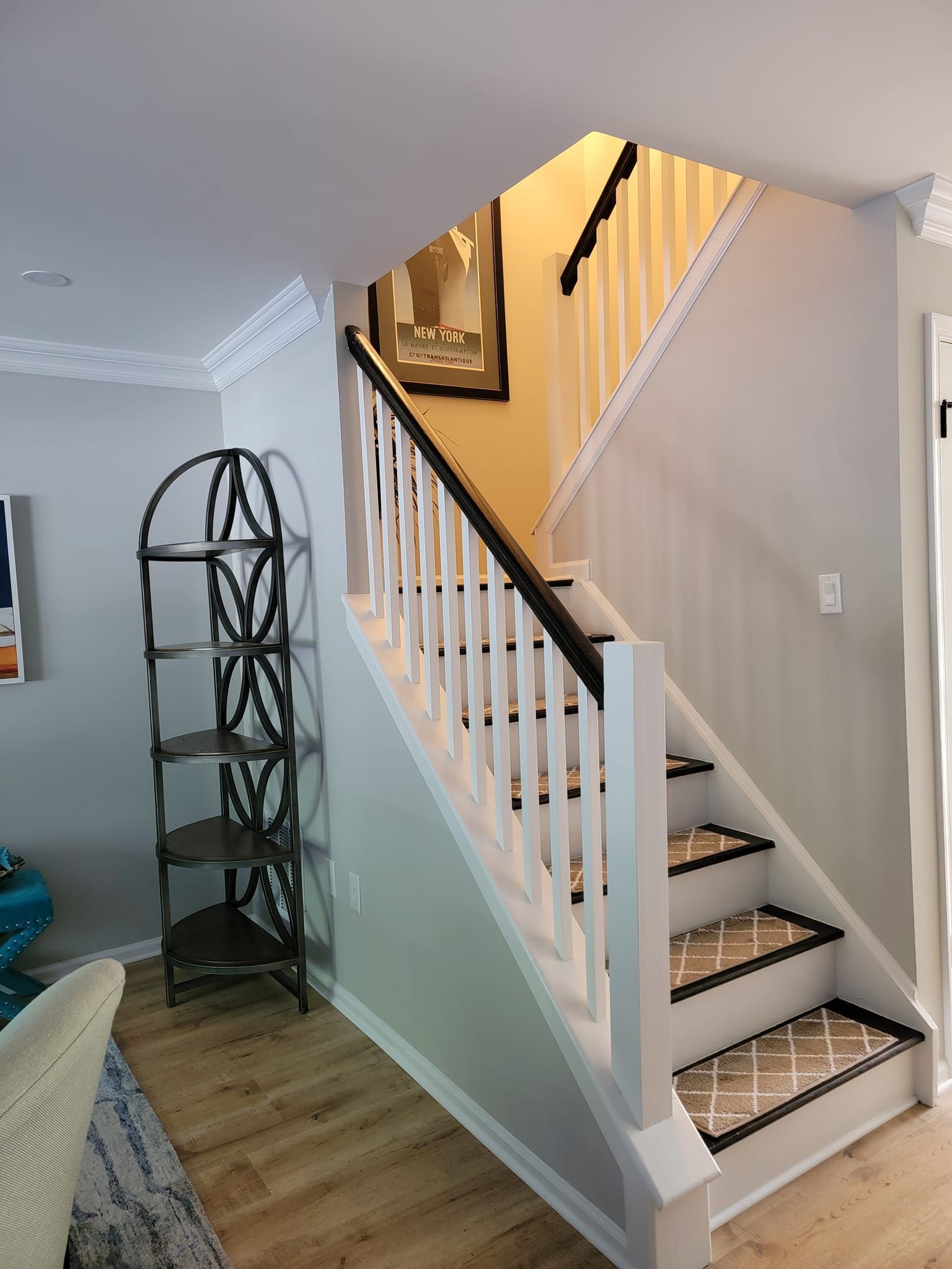 A living room with a staircase leading up to the second floor