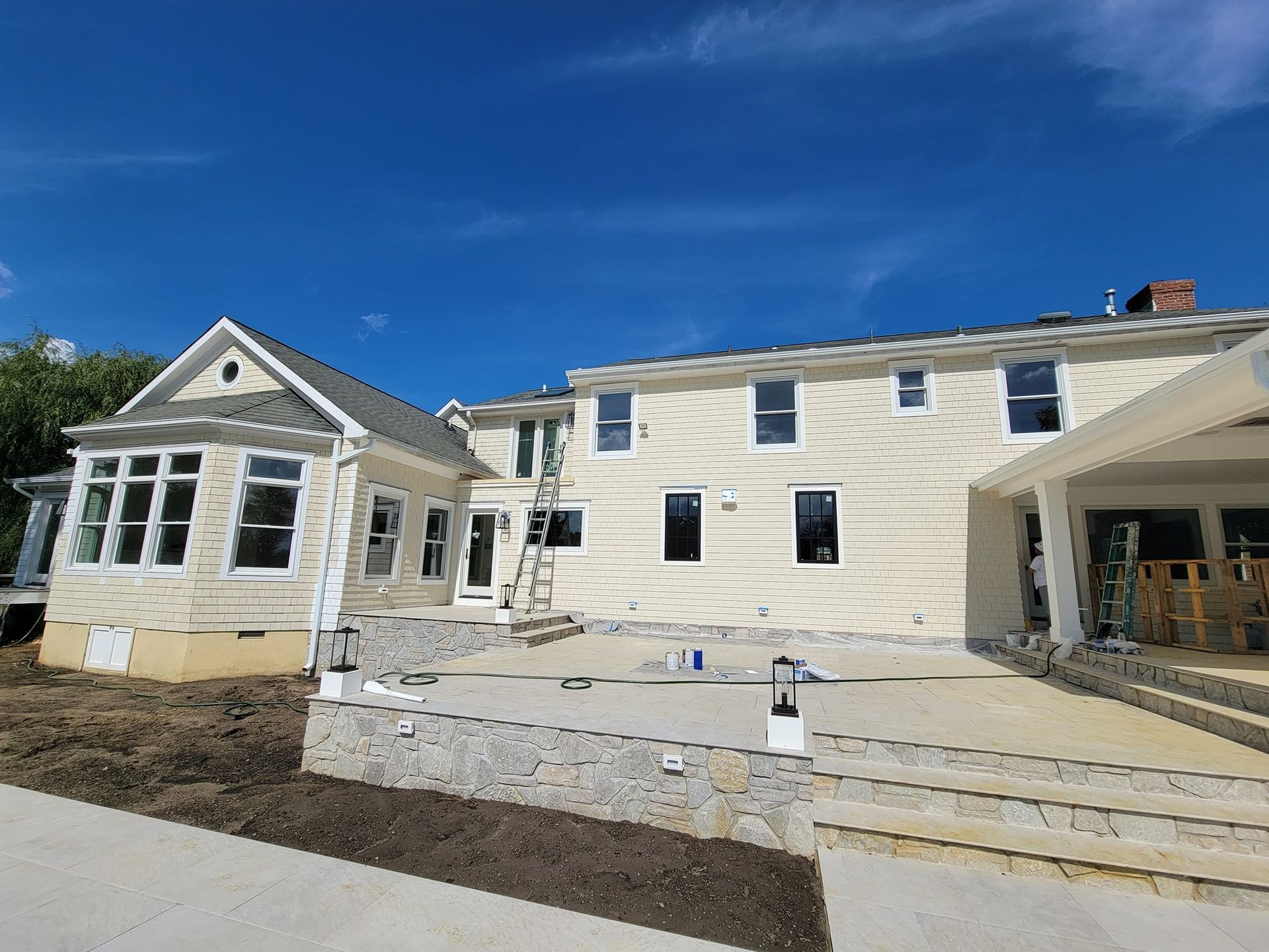 A large white house with a lot of windows is being built.