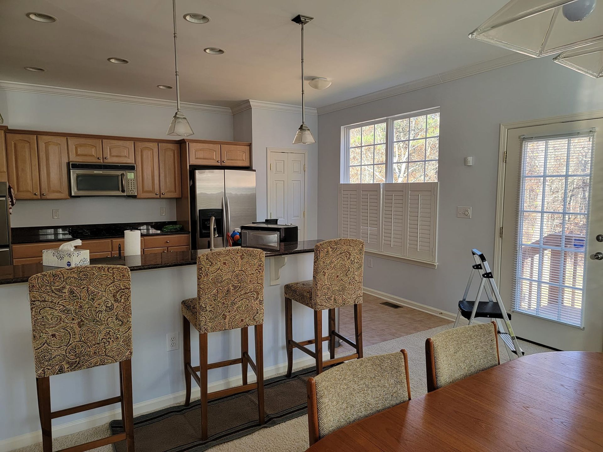 A kitchen with a table and chairs in it