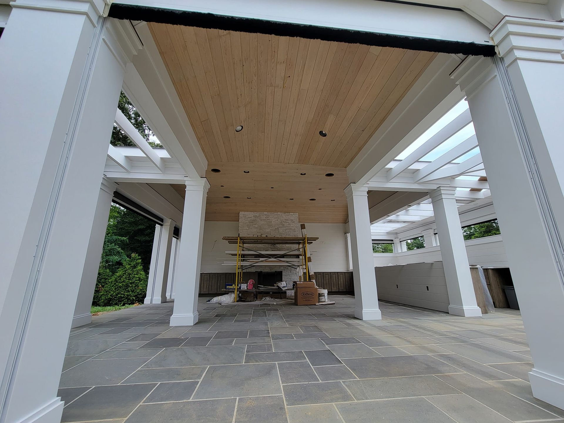 A large room with a wooden ceiling and a fireplace