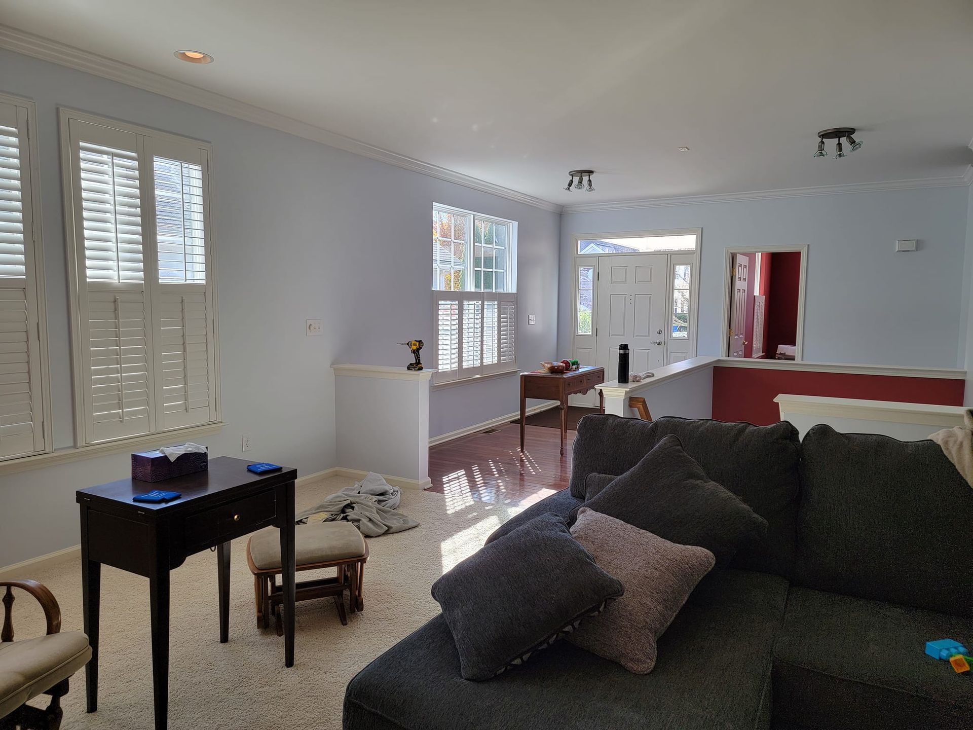 A living room with a couch and a desk