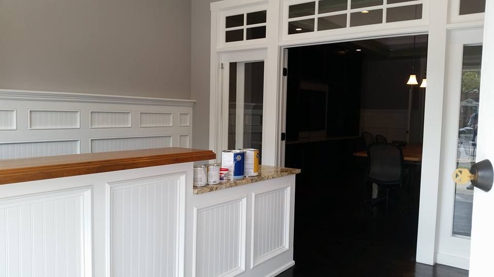 A room with a counter and a door leading to a room.