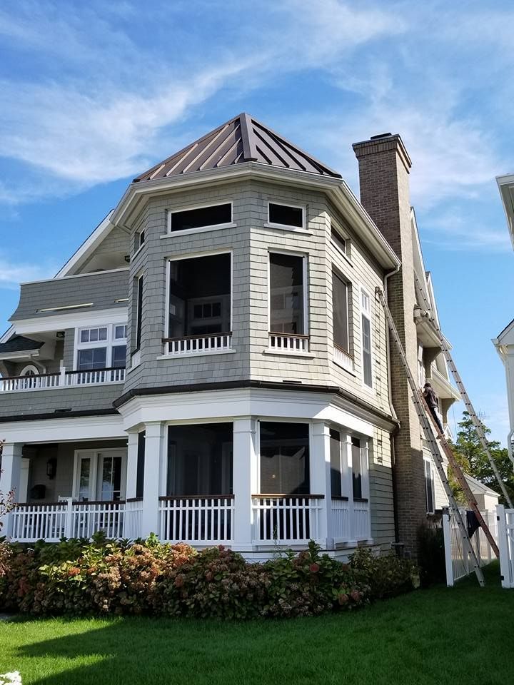 A large house with a screened in porch and stairs