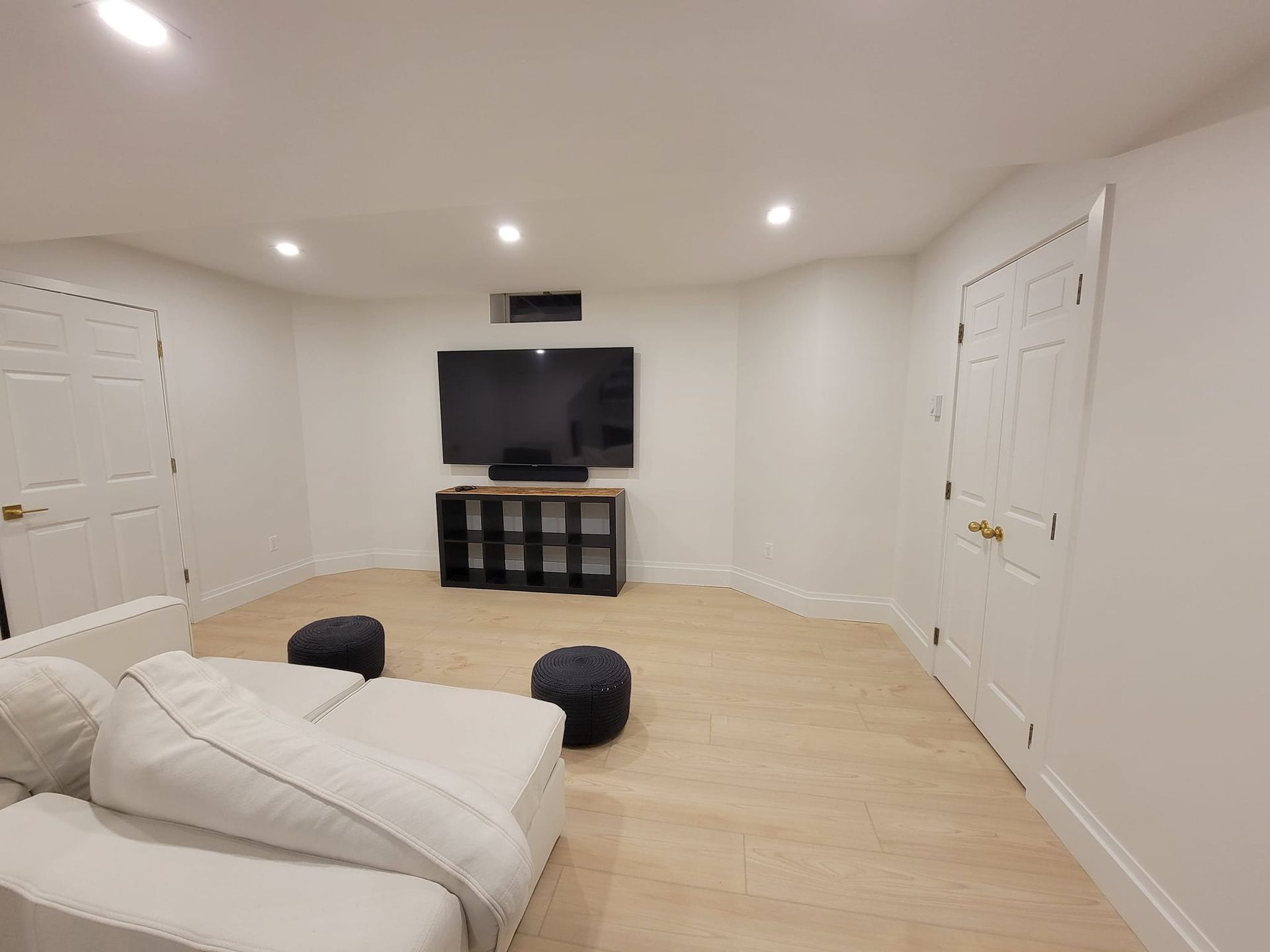 A living room with a couch and a flat screen tv.