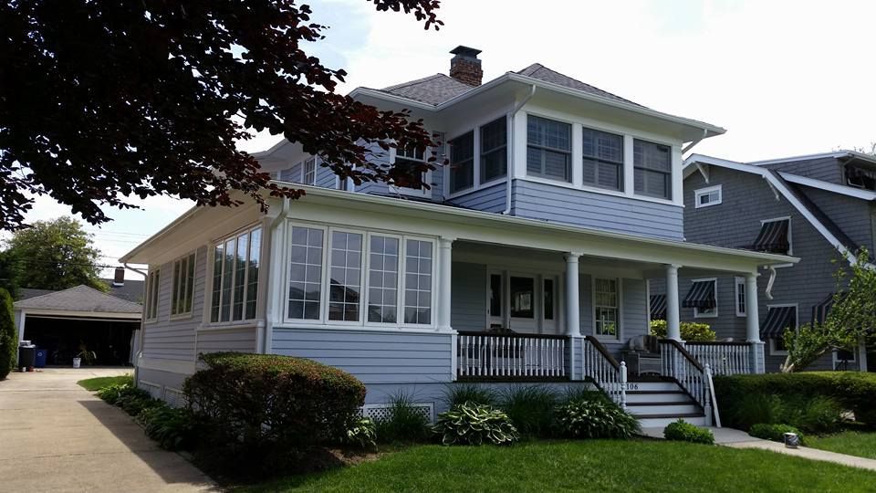 A house with a large porch and lots of windows