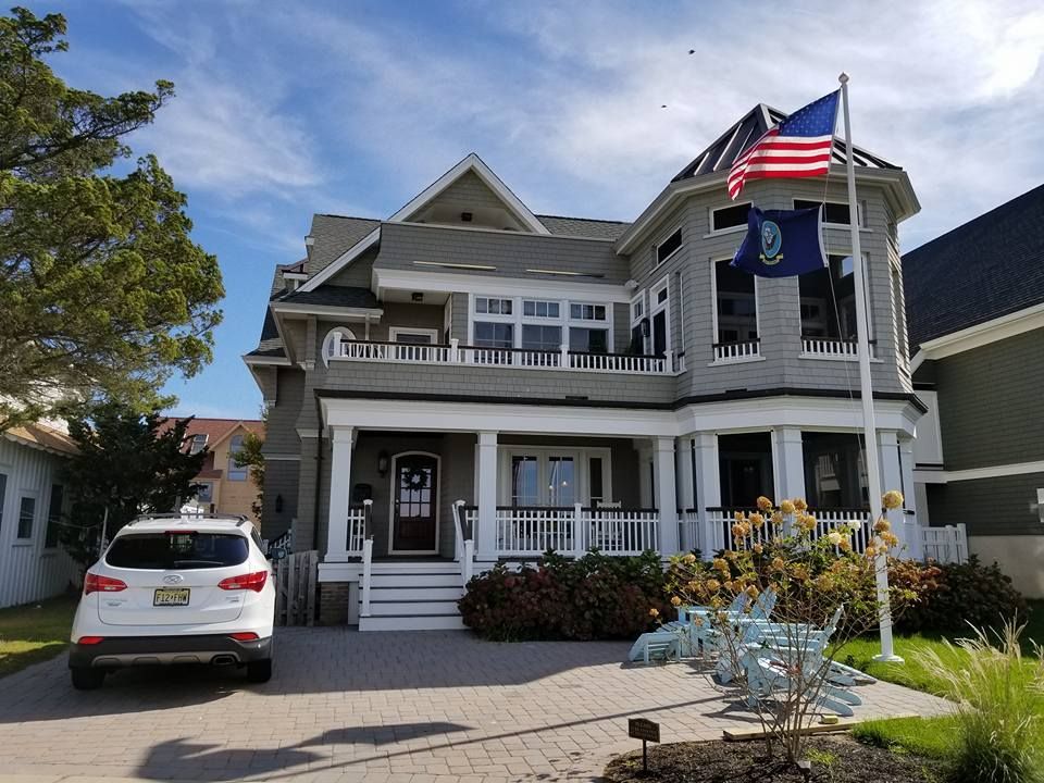 A large house with a car parked in front of it