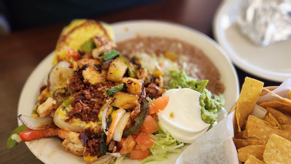 A close up of a plate of mexican food on a table.
