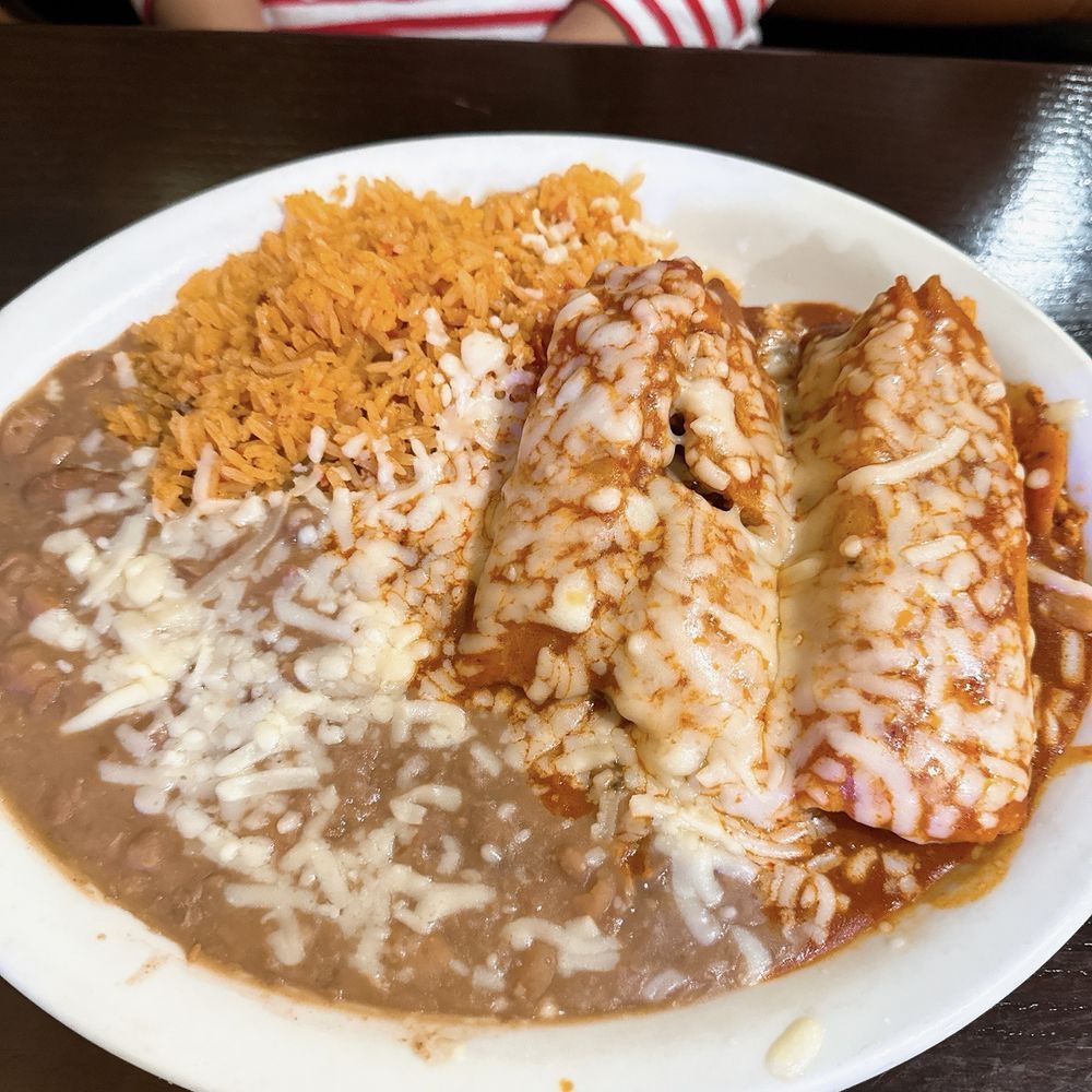 A plate of food with beans and rice on a table