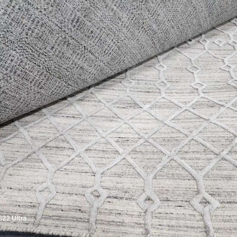 A close up of a rug with a pattern on it.