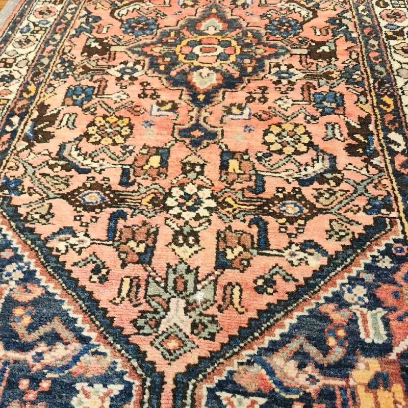 A close up of a rug with a floral pattern on it.