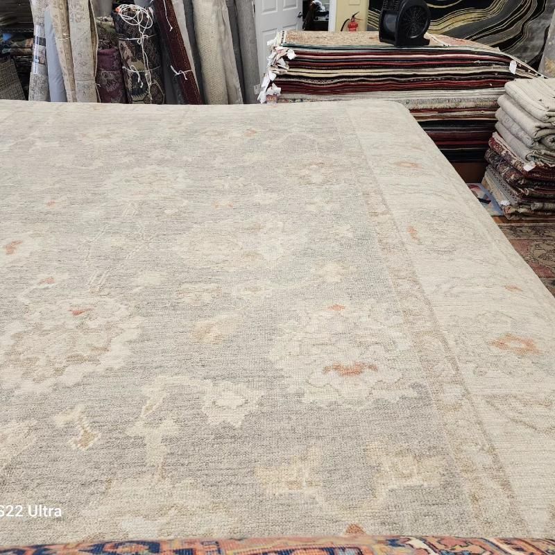 A large rug is sitting on top of a table in a store.