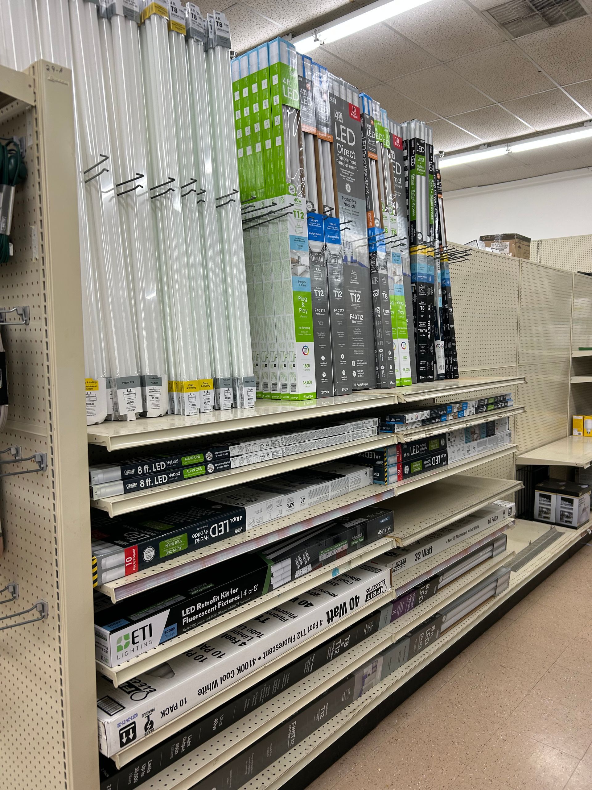A store aisle filled with shelves filled with lots of items.