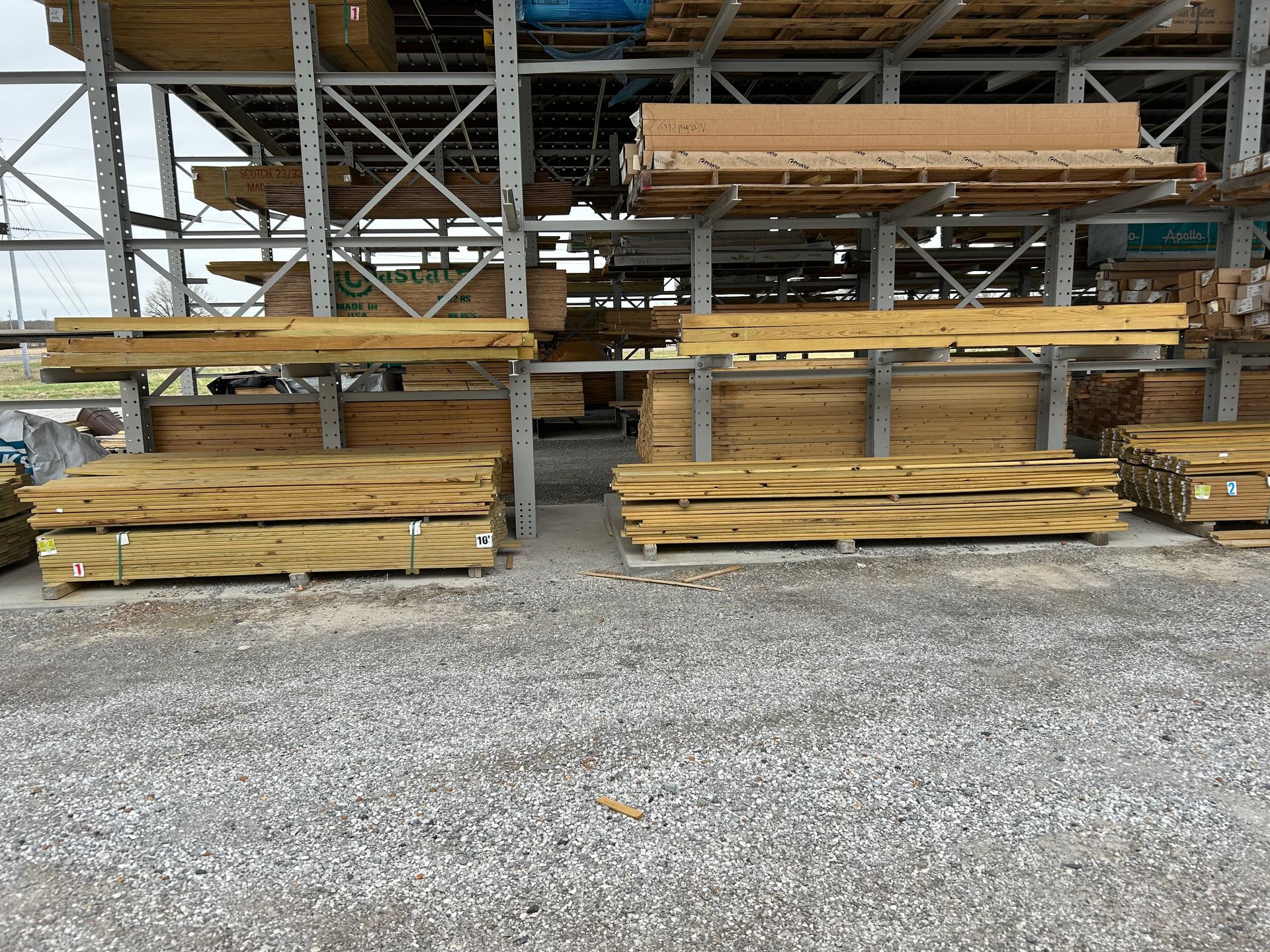 A warehouse filled with lots of wooden boards and pallets.