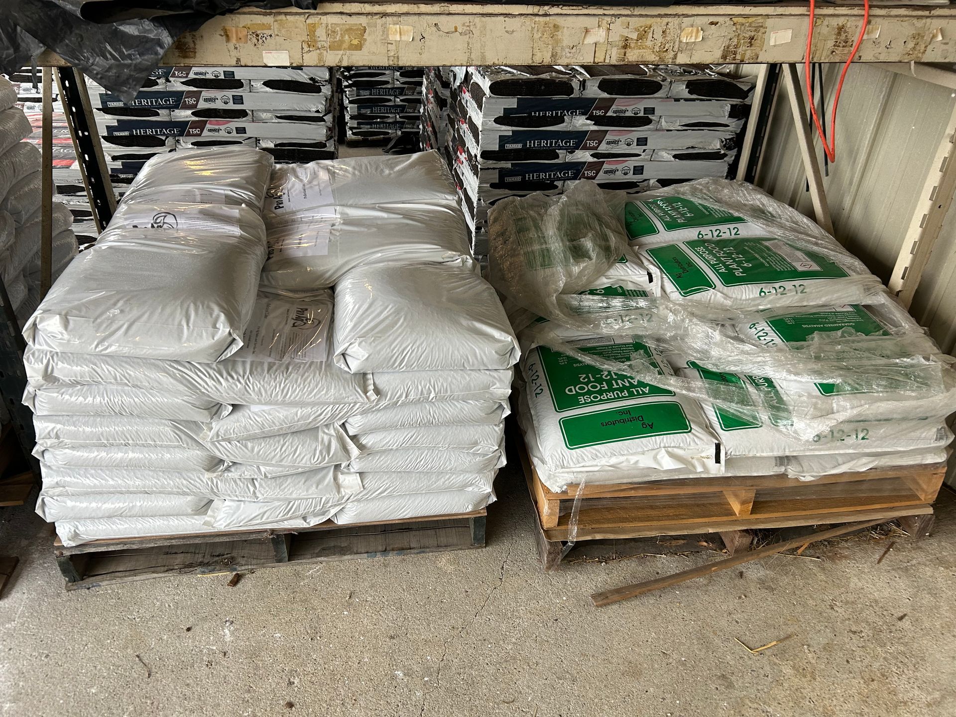 A bunch of bags are stacked on top of each other on a wooden pallet.