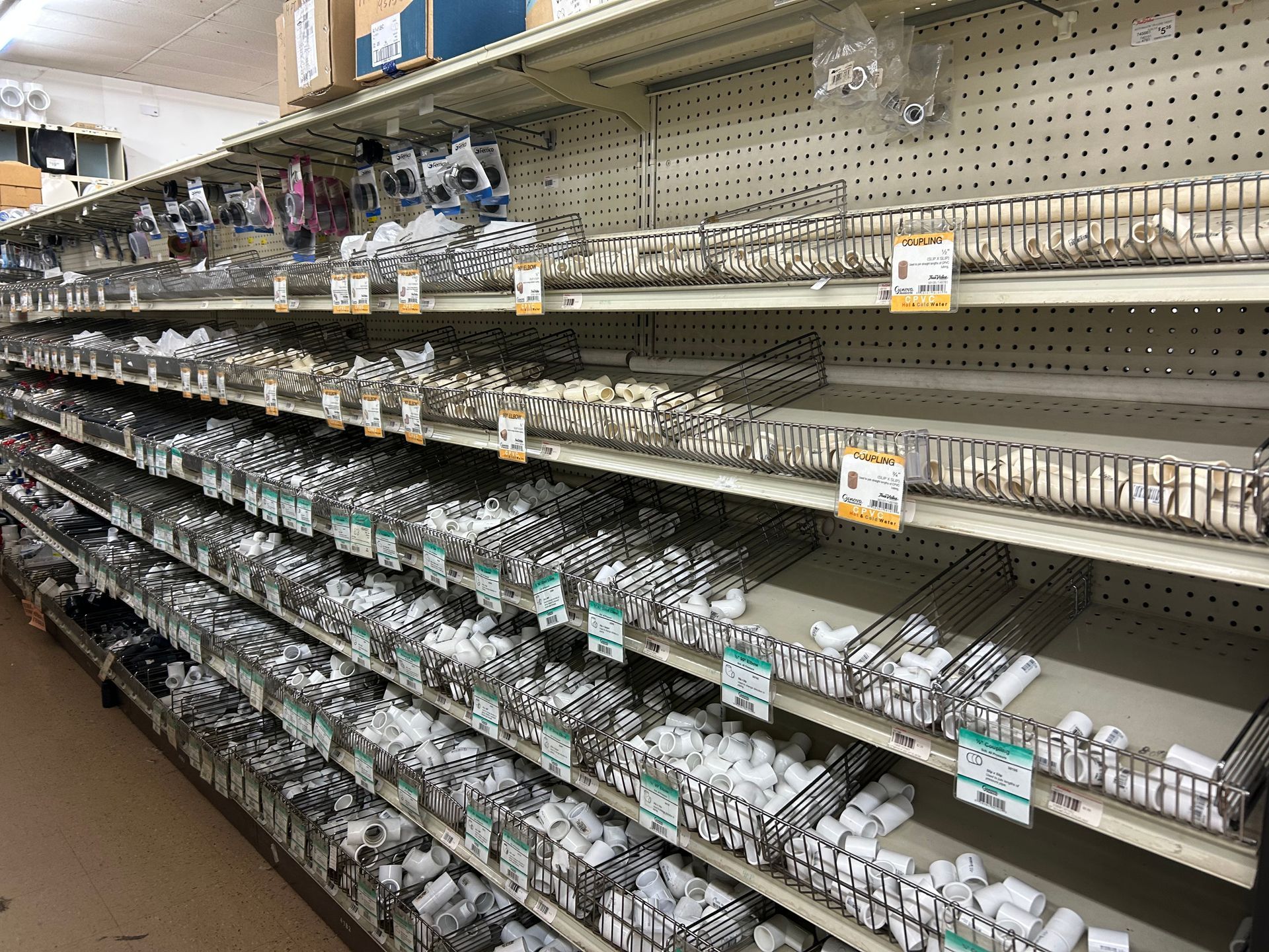 A store aisle filled with shelves filled with lots of different items.