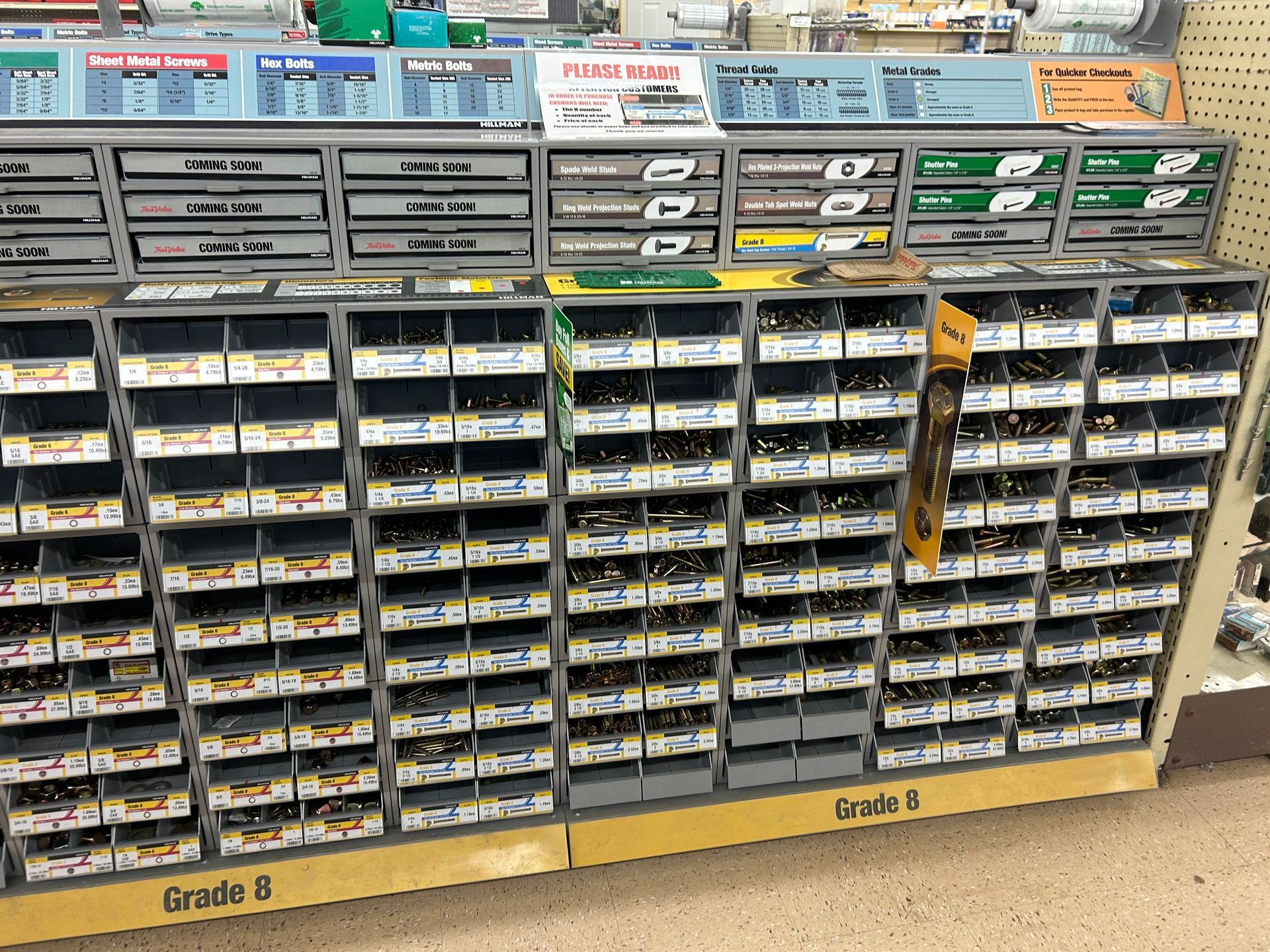 A store shelf filled with lots of screws and nuts