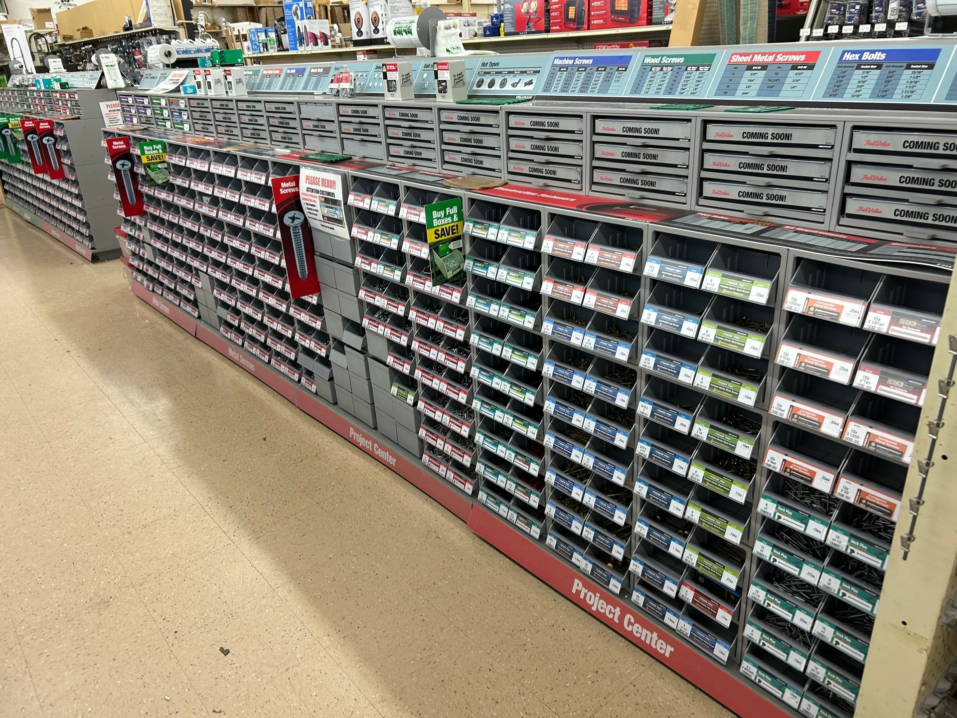 A row of shelves in a hardware store filled with lots of different items