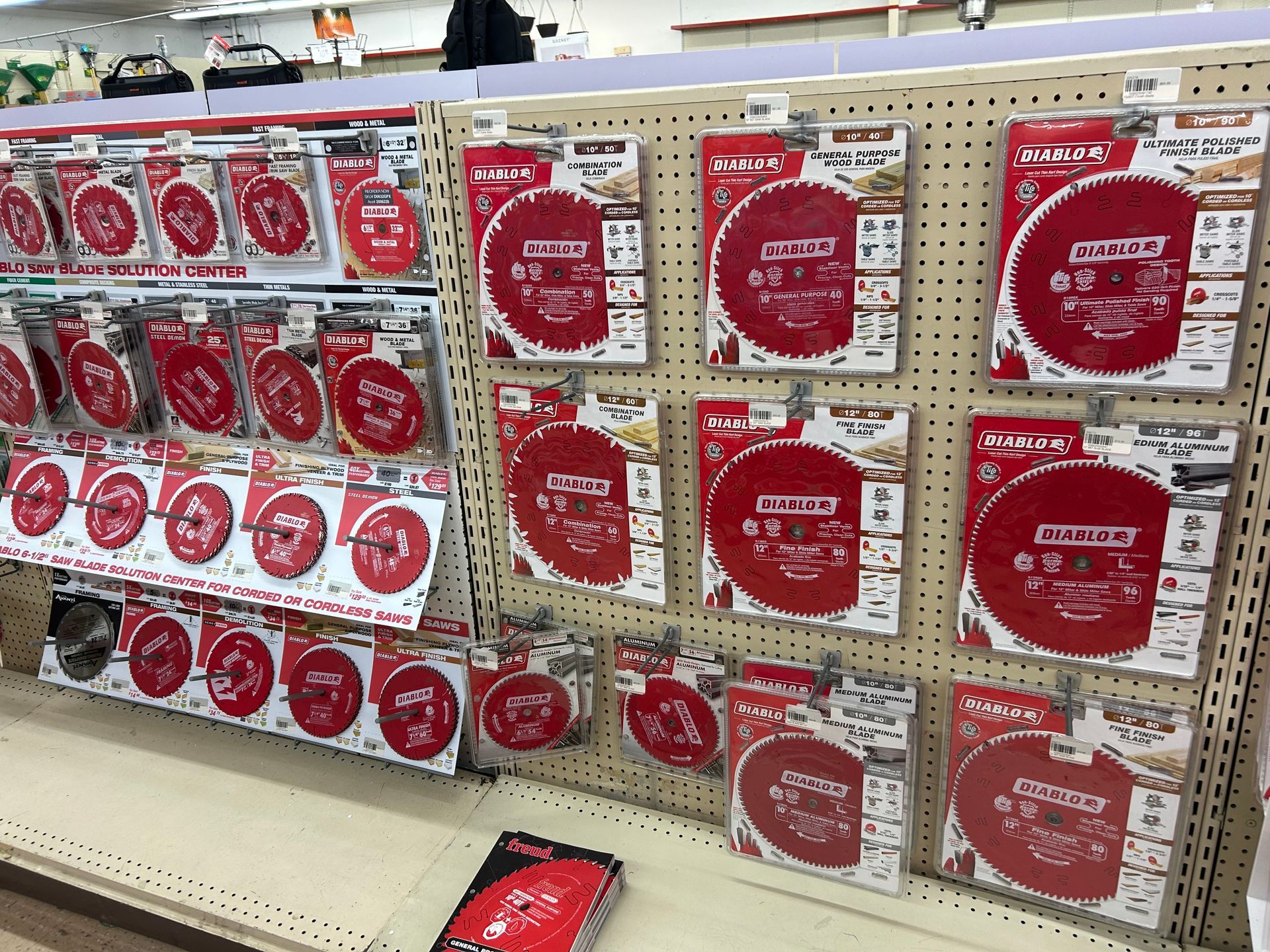 A shelf in a store filled with lots of red discs.