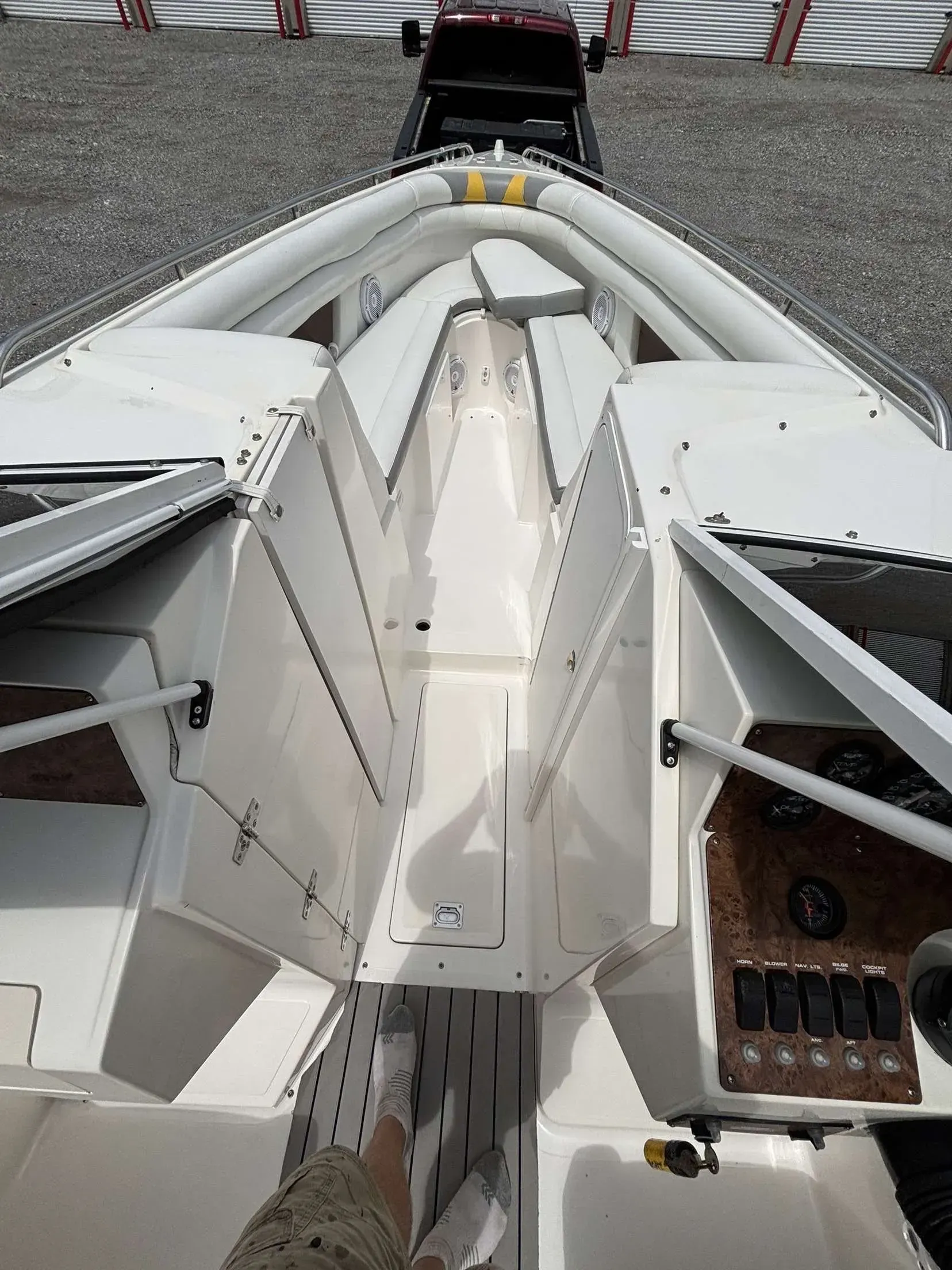 White motorboat interior with angled metal panels, a cockpit, and gauges.
