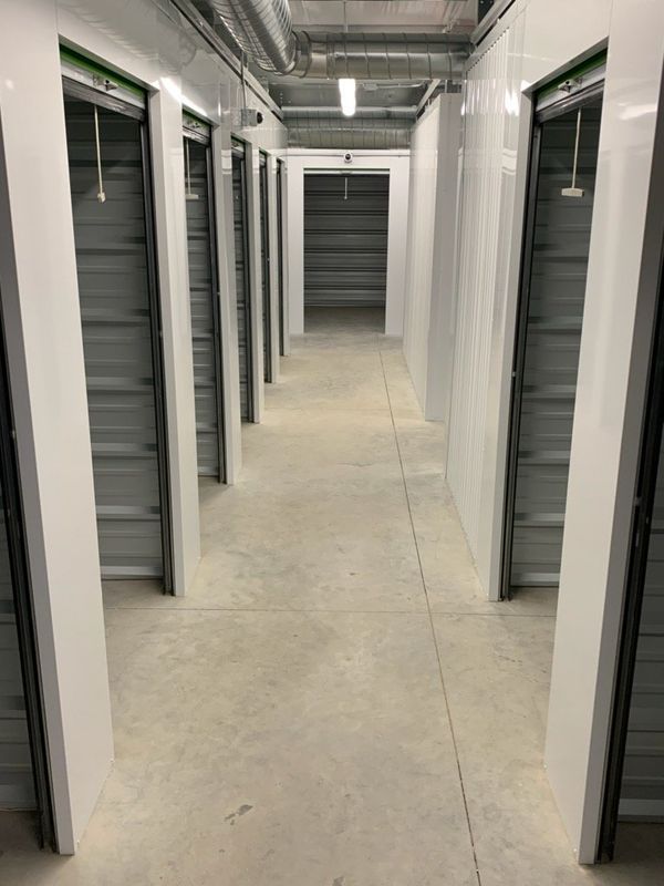 A long hallway with a lot of doors in a building.