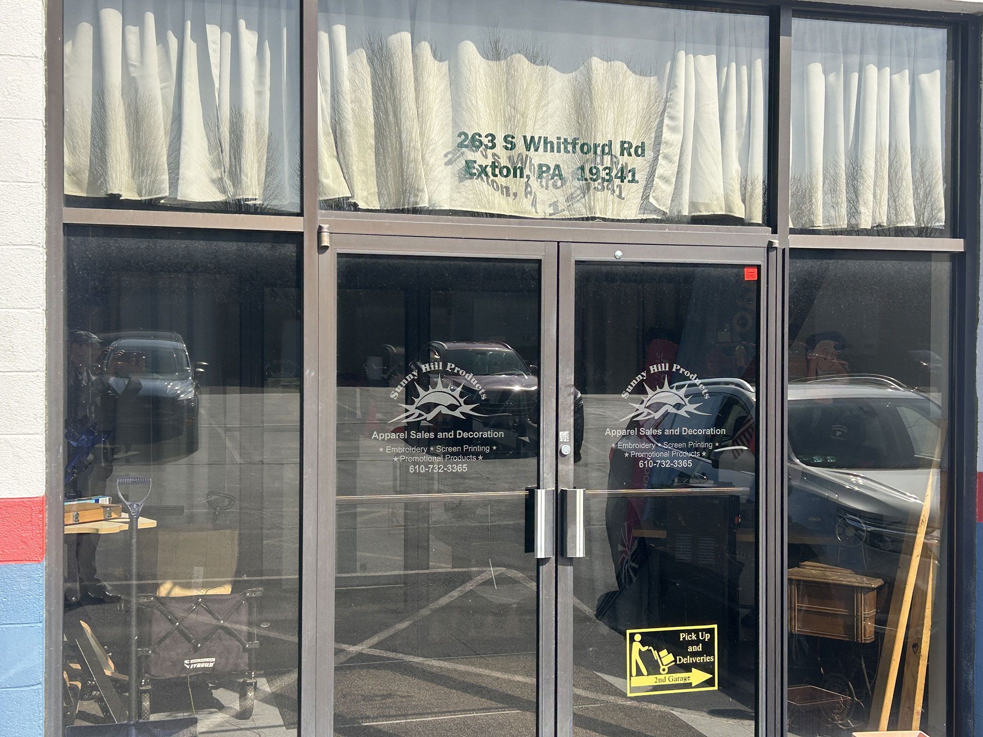 Double glass doors of a commercial storefront with address 263 S. Whitton Rd, Phoenix, AZ printed on the top window.