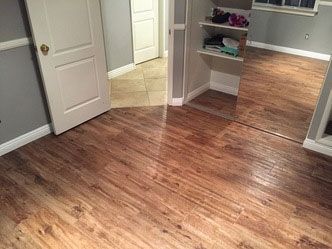 A room with hardwood floors and a large mirror.
