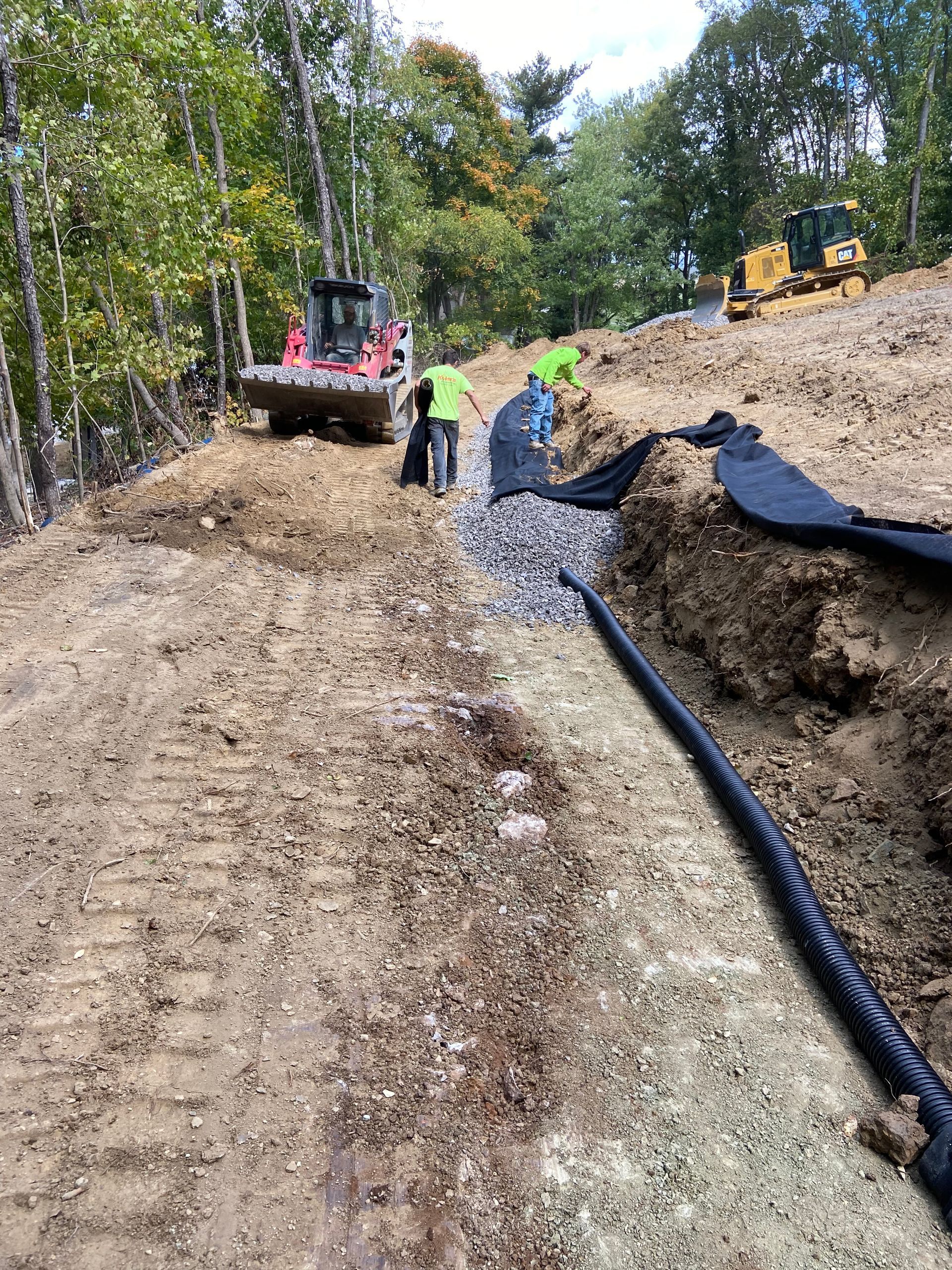 A bulldozer is driving down a dirt road.