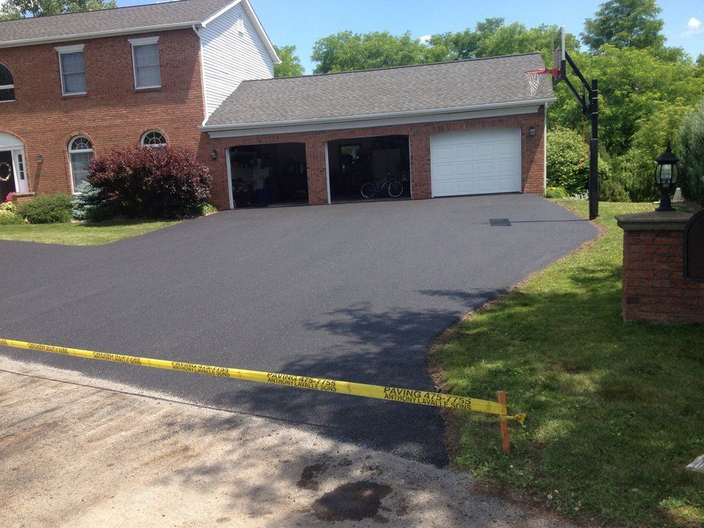 A brick house with a basketball hoop in front of it