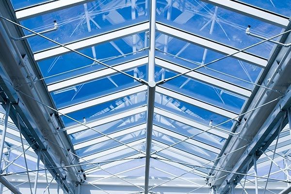 Looking up at the sky through a glass roof