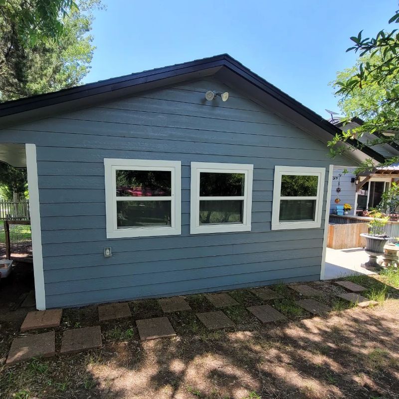 A small house with a lot of windows on it