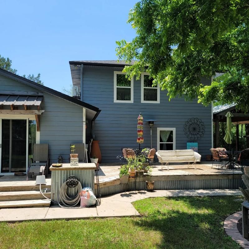 The backyard of a house with a patio and a couch