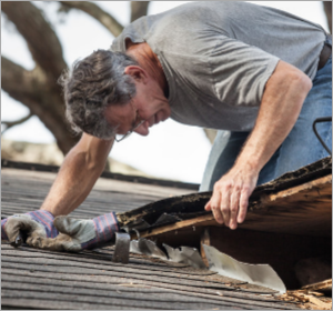 man inspecting roof
