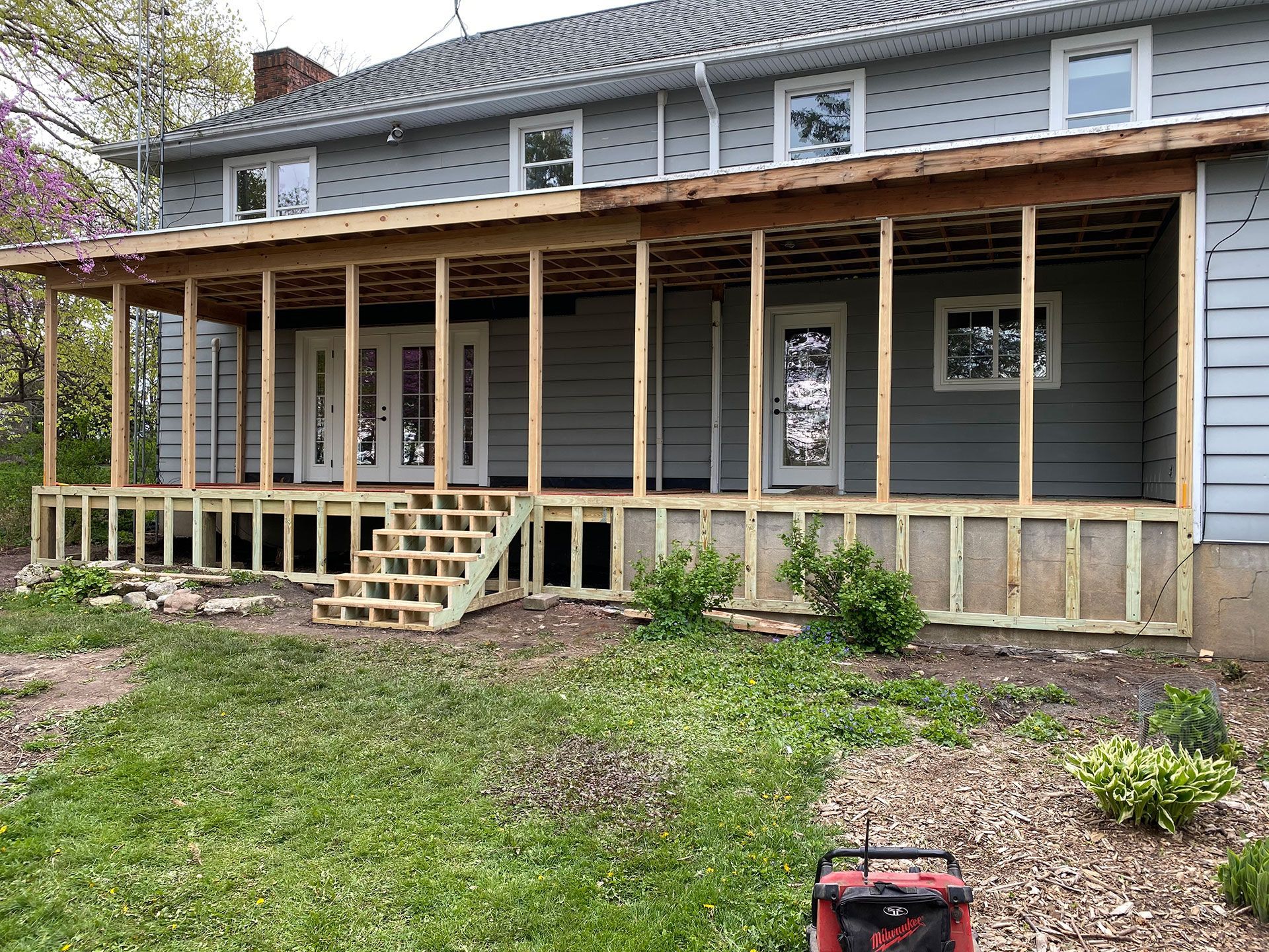 A large porch is being built on the side of a house.