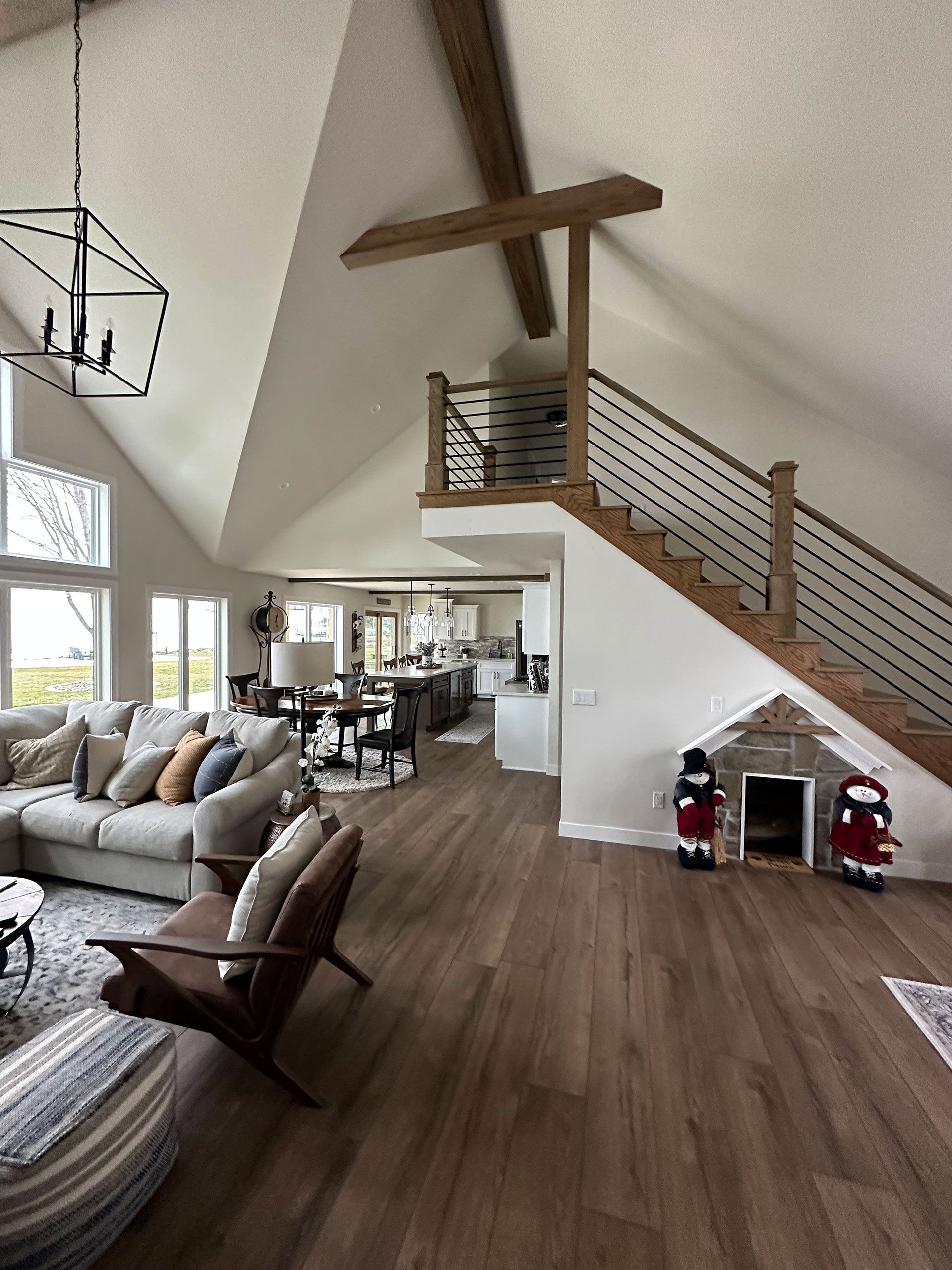 A living room with a staircase leading up to the second floor.
