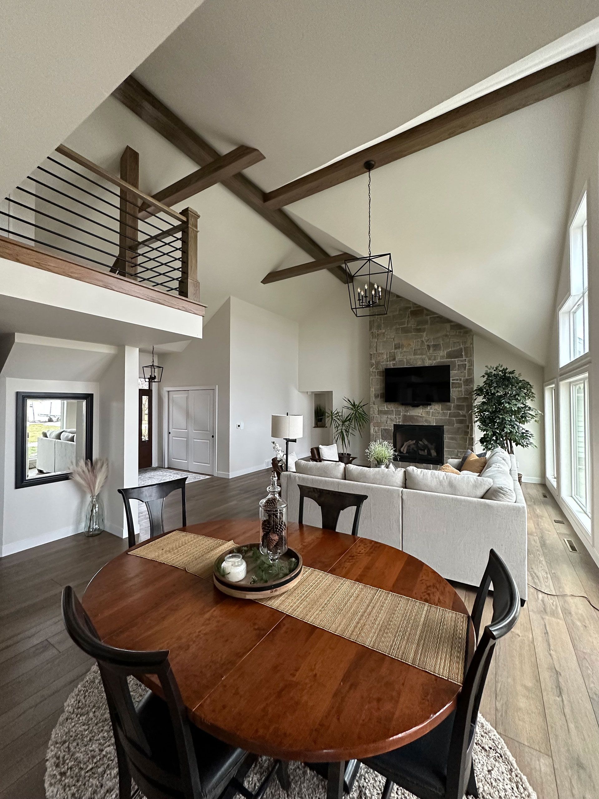 A living room with a table and chairs and a fireplace.