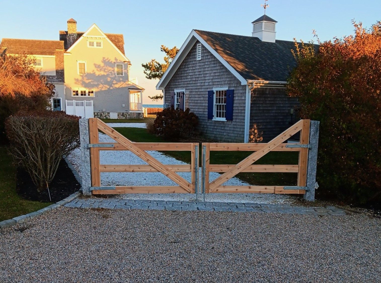 A house with a wooden gate in front of it.