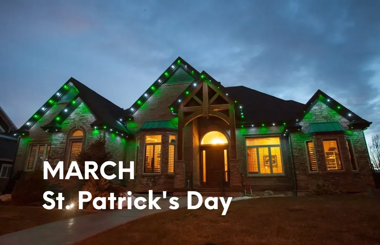 House decorated with green and white lights for St. Patrick's Day.