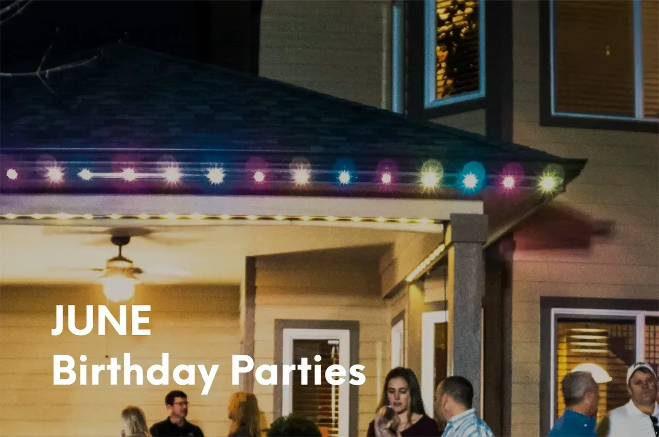 House with multi-colored lights, people gathered outside, text 