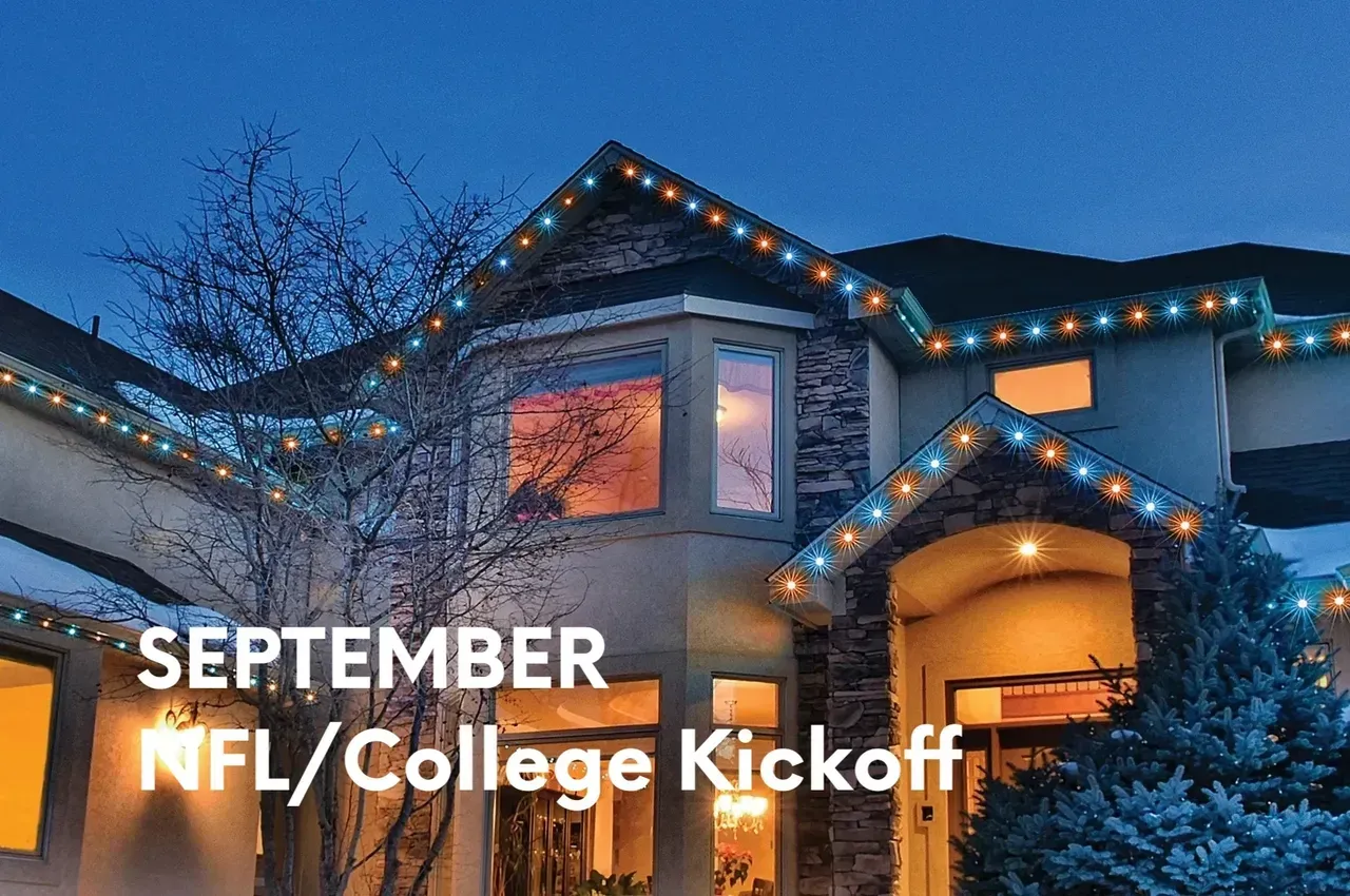House decorated with orange and blue lights, celebrating September NFL/College kickoff.